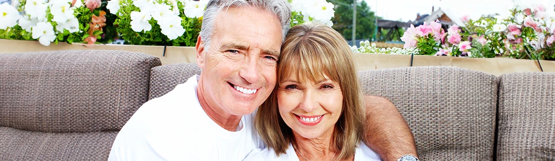 Senior Couple Sitting Outside Smiling