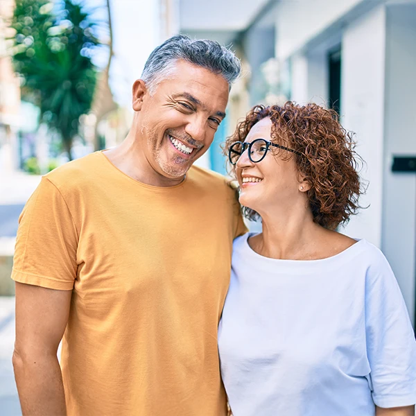 Dentist-Couple-Smiling-And-While-Walking-Down-The-Street-600x600-Moto.webp